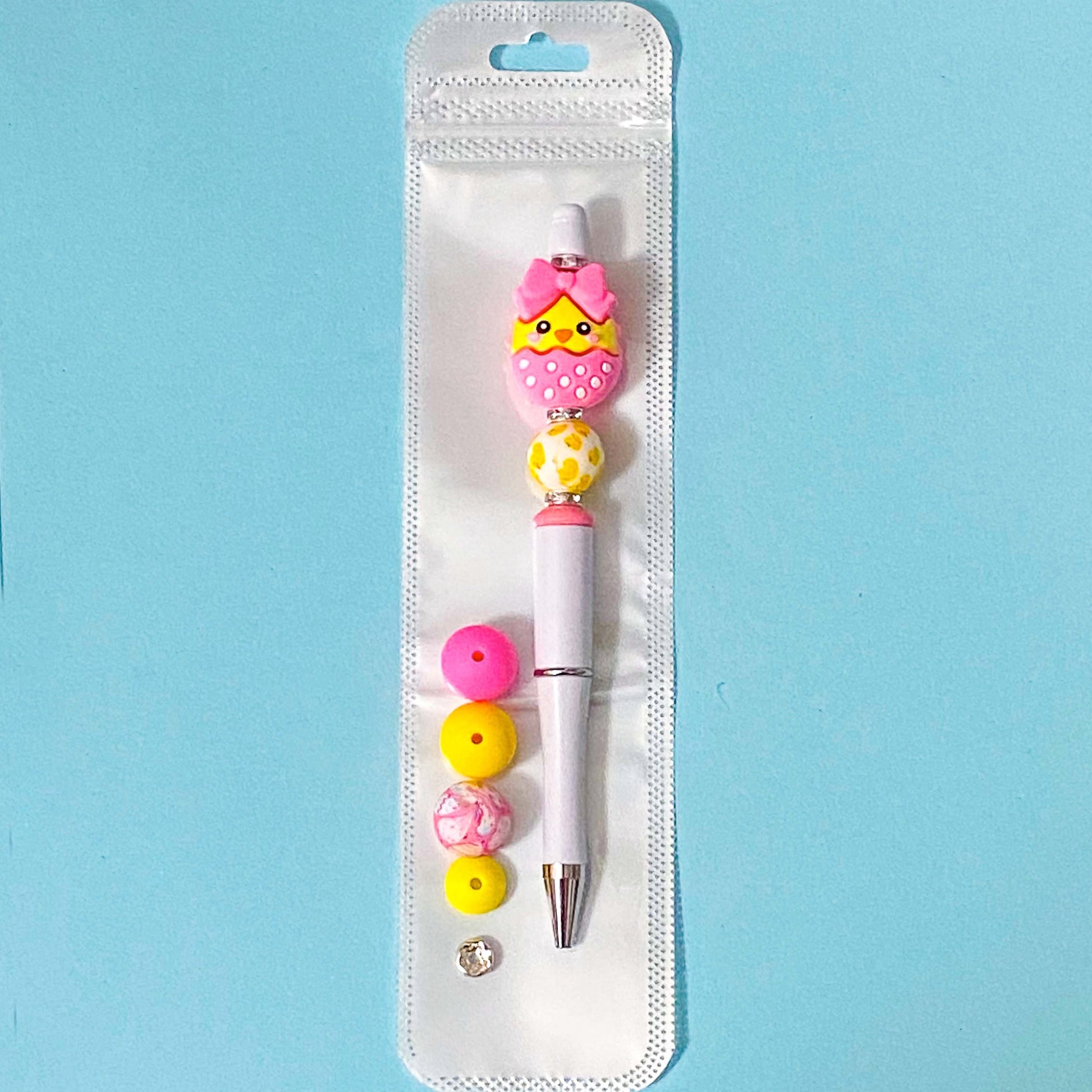 hot pink and yellow chick silicone bead pen diy kit on blue background