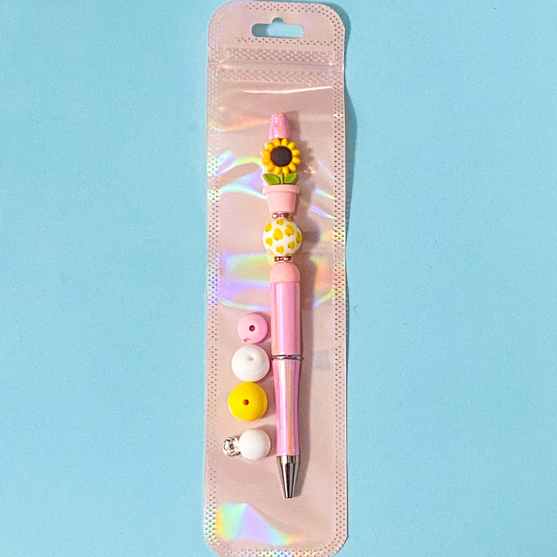 sunflower in pink pot silicone beads diy beading pen kit on a blue background