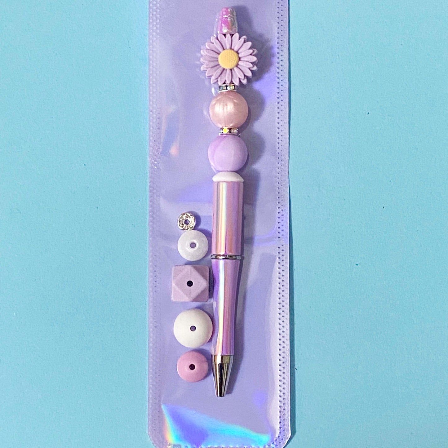 lilac daisy silicone beaded pen kit on a blue background