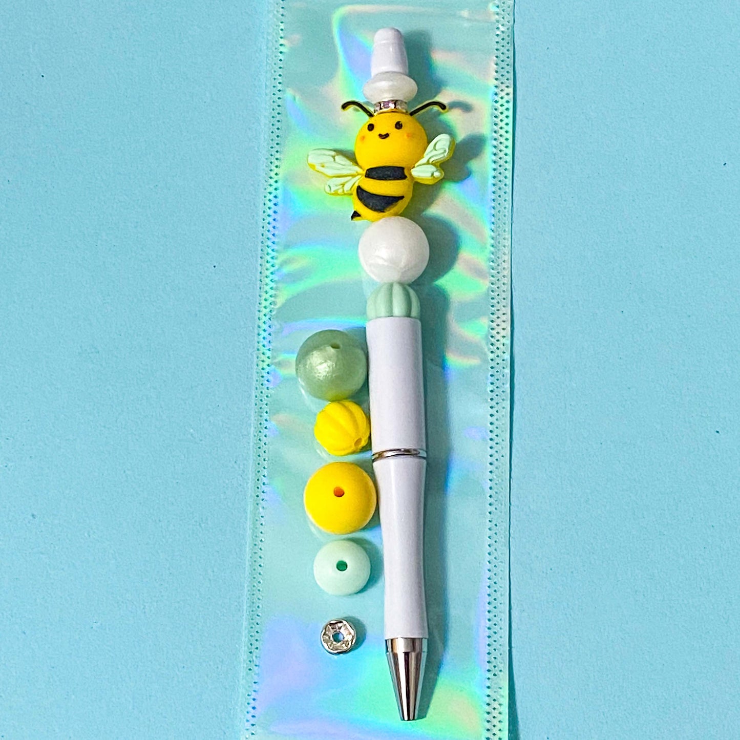 yellow and mint silicone bee build your own beaded pen diy kit on blue background