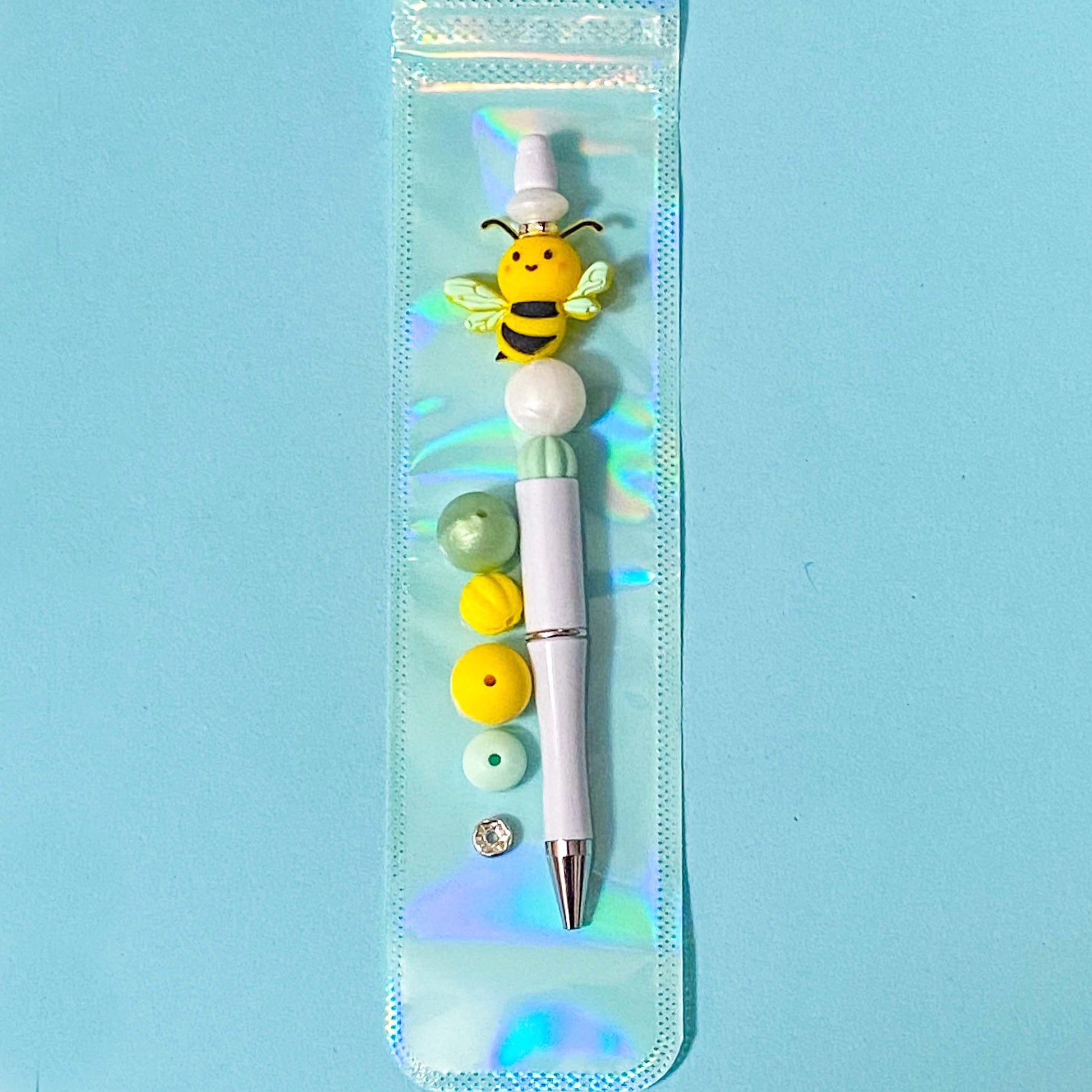 yellow and mint silicone bee build your own beaded pen diy kit on blue background