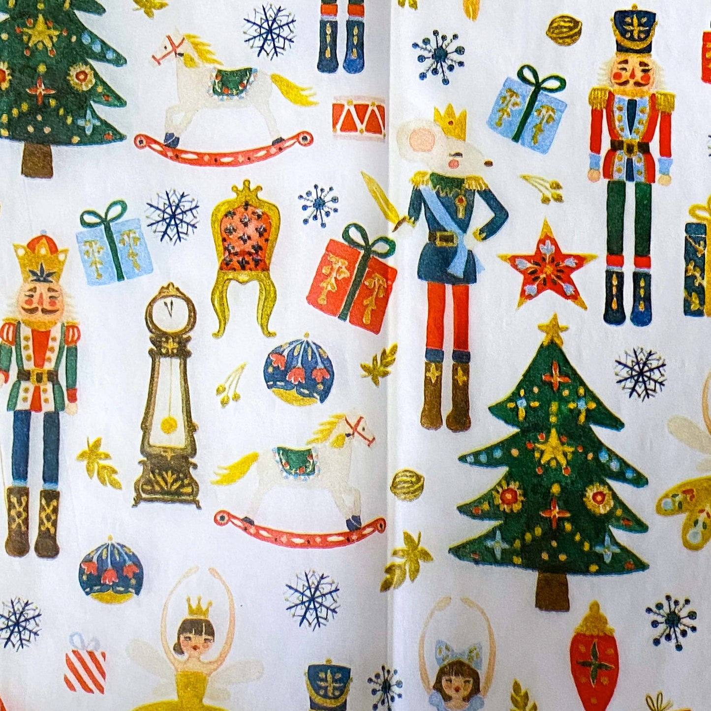 nutcracker suite christmas tissue paper wrap with clara, the sugar plum fairy, tree, toys and the king of the rats mouse on a white background.