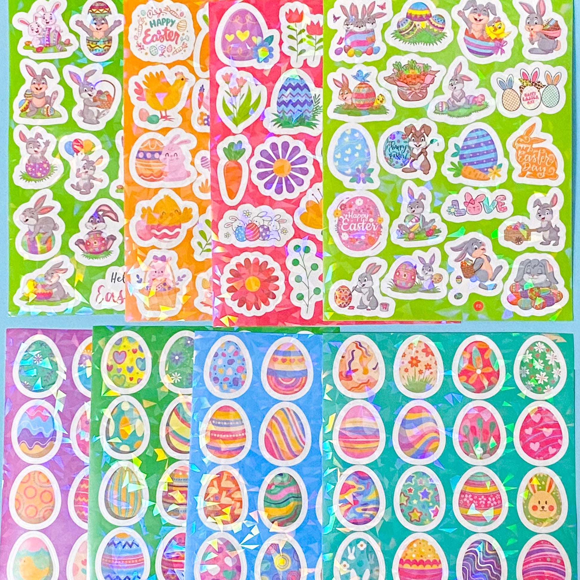 Collection of Easter-themed holo foil glittery stickers with bunnies, eggs, and flowers on colourful backgrounds.