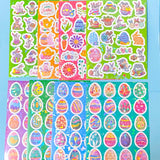 Collection of colorful Easter-themed stickers on a blue background with holo foil glitter highlights