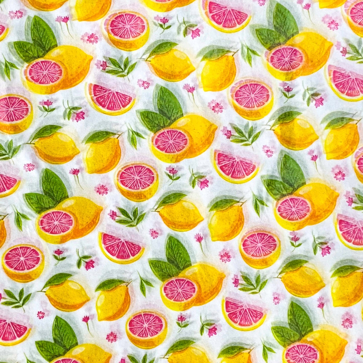 tissue paper sheets in Pattern of lemons, pink grapefruit wedges, and leaves on a white background