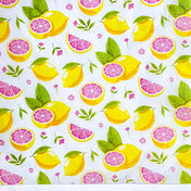 tissue paper sheets in Pattern of lemons, pink grapefruit wedges, and leaves on a white background