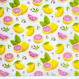 tissue paper sheets in Pattern of lemons, pink grapefruit wedges, and leaves on a white background