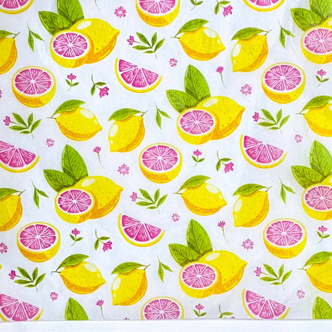tissue paper sheets in Pattern of lemons, pink grapefruit wedges, and leaves on a white background