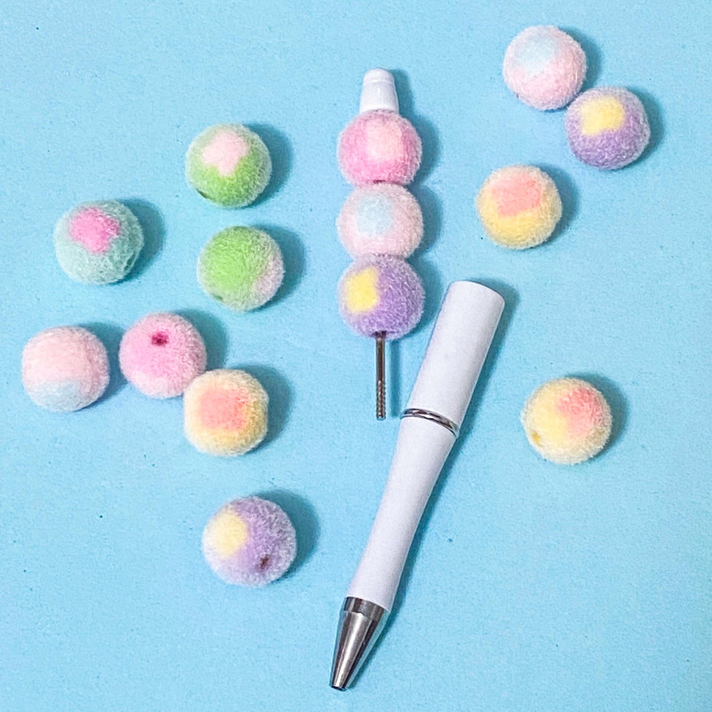 round flocked acrylic 16mm bunny head pattern beads on a beaded pen base on a blue background
