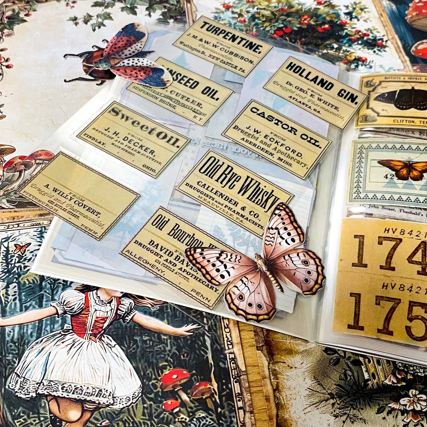 alice in wonderland junk journal kit with vintage botanical scrapbook paper, mushroom labels, insect die cuts and a 20 page clear sticker book