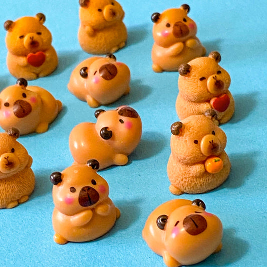 resin 3D miniature capybara figurines with oranges, hearts and cute expressions. Set of 3 different animals i9n organza bag
