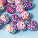 multicoloured sparkly rhinestone pave beads on a blue background