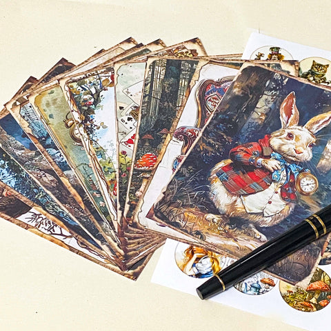 alice in wonderland inspired scrapbook paper set with rabbit illustration, fanned mini vintage papers and coordinating sticker sheet on neutral background