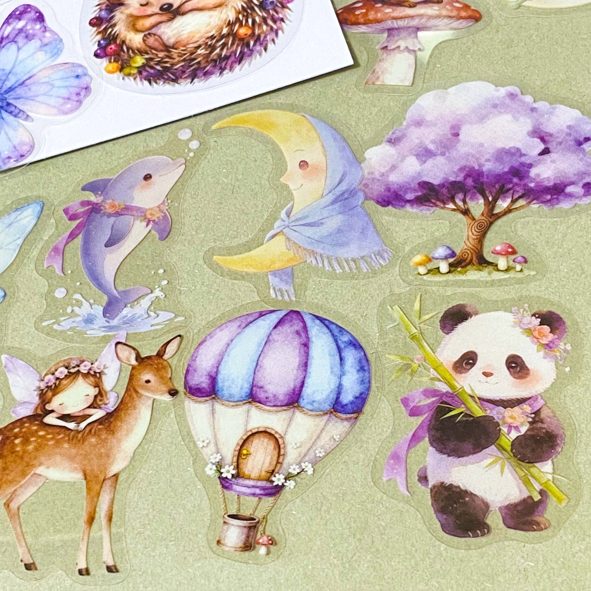 collection of 50 different pastel storybook stickers featuring fairies, woodland animals, flowers, castles, moons and butterflies and enchanted cottagecore illustrations in soft lilac and lavender tones.