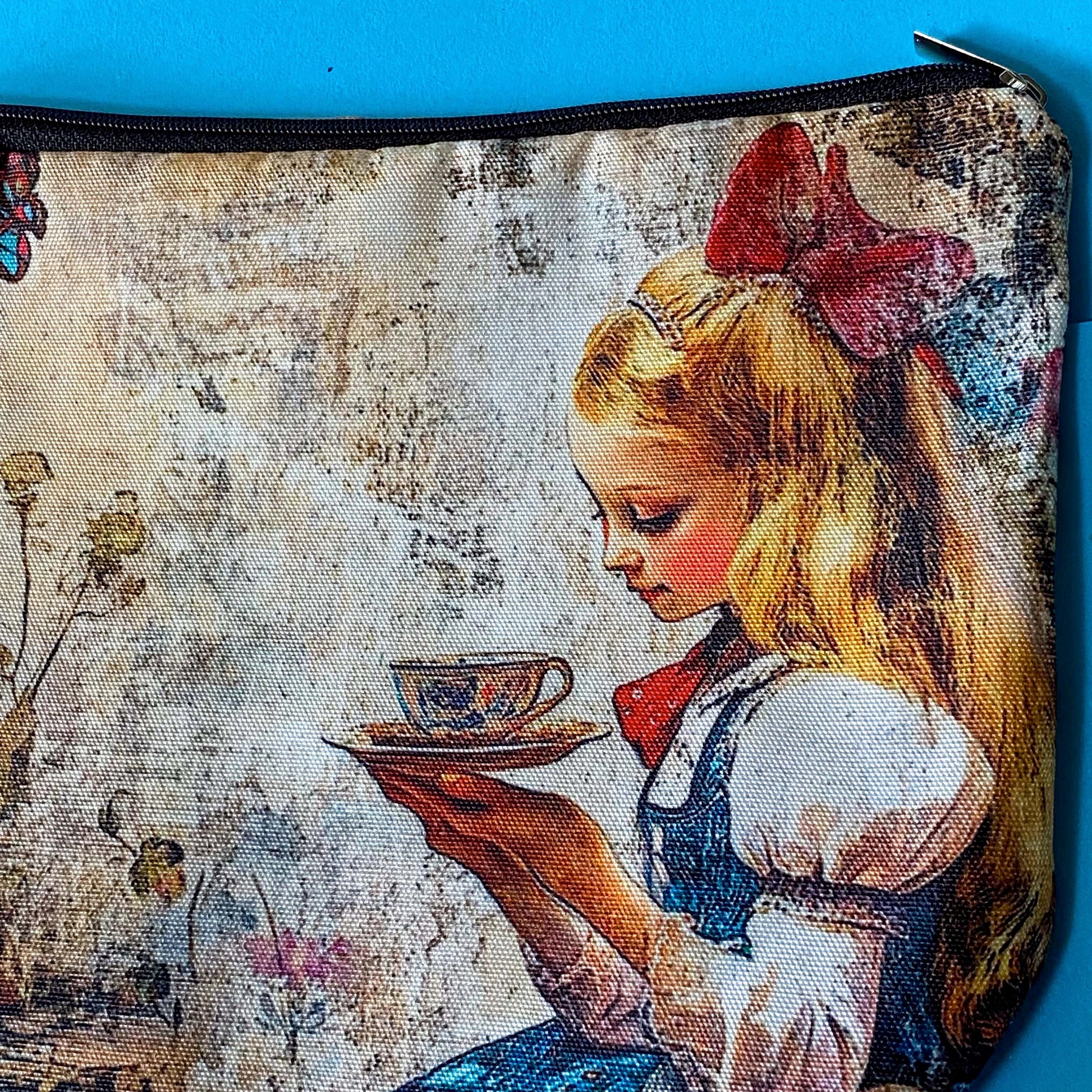 lightweight fabric zip pouch featuring a vintage inspired alice in wonderland scene with a girl enjoying afternoon tea with a rabbit on softly aged storybook background. uk cute gifts shop.