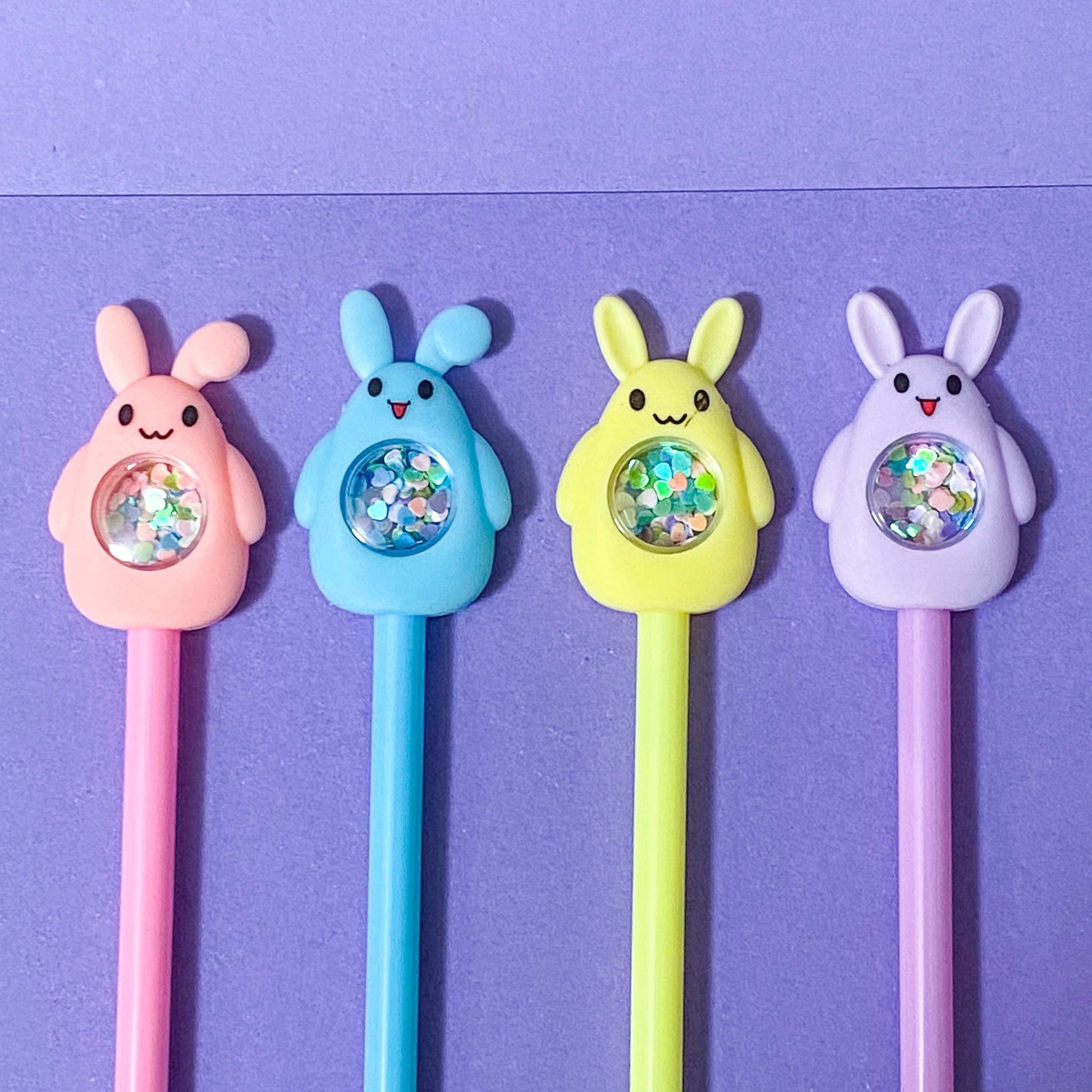 sequin shaker topper pens in a bunny shape on a purple background