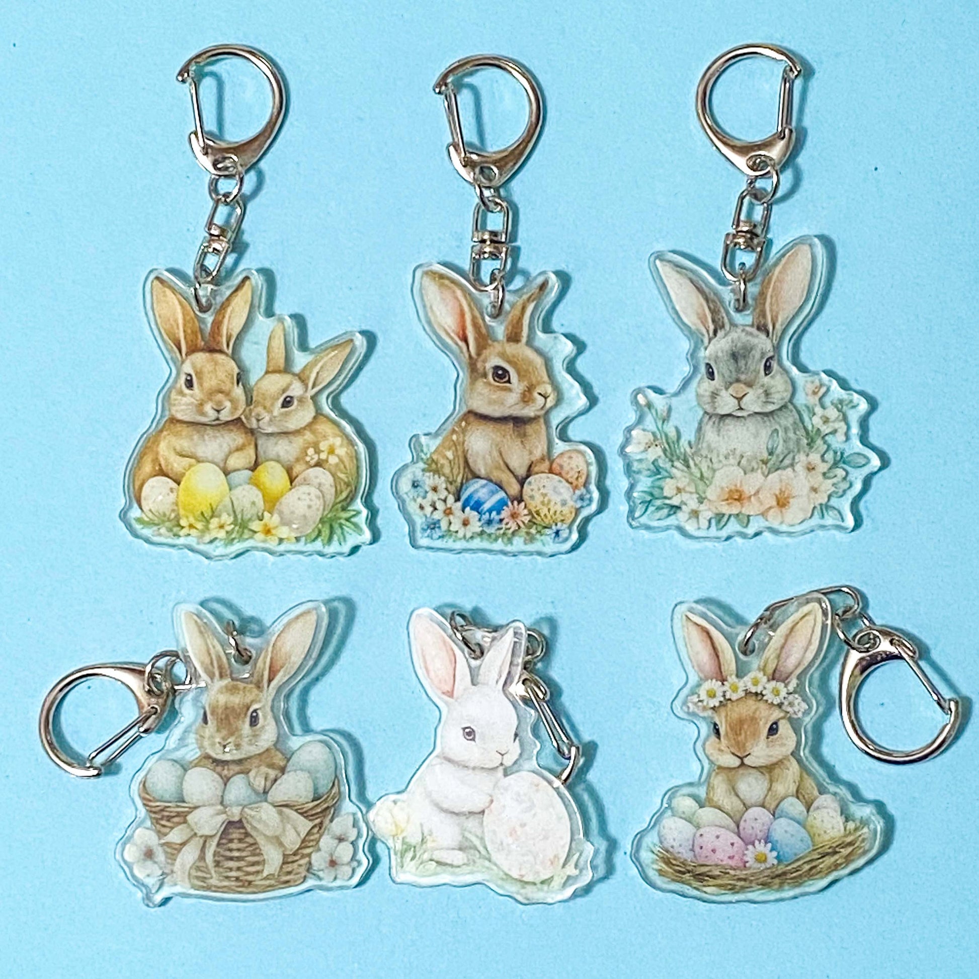 spring keyring or bag charms with cute bunny rabbits on a blue background