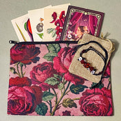 crimson vintage rose letterbox gift set featuring a floral canvas roses pouch, vintage botanical postcards, decorative sticker book with floral illustrations and scrapbook papers and an adjustable red crystal bracelet with rose details and black cord.