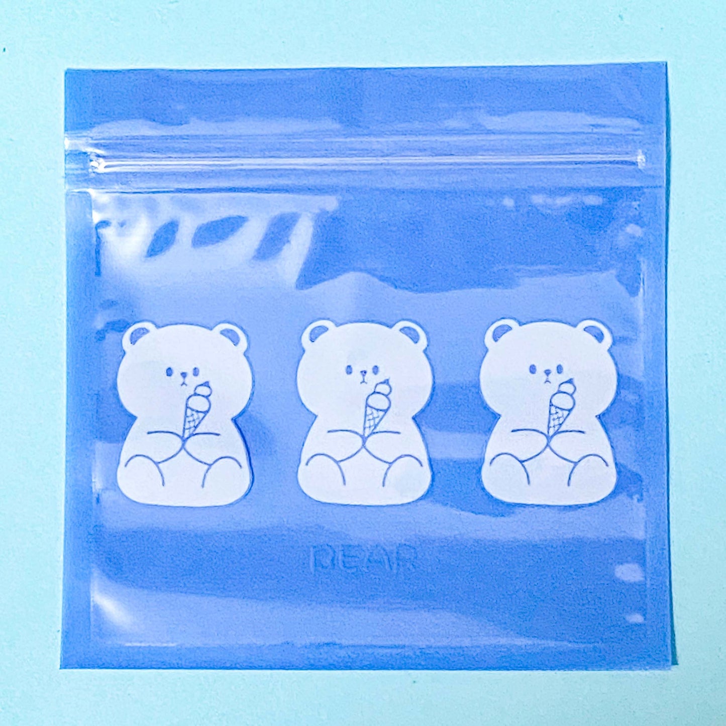 Clear plastic bag with bear illustrations on a blue background