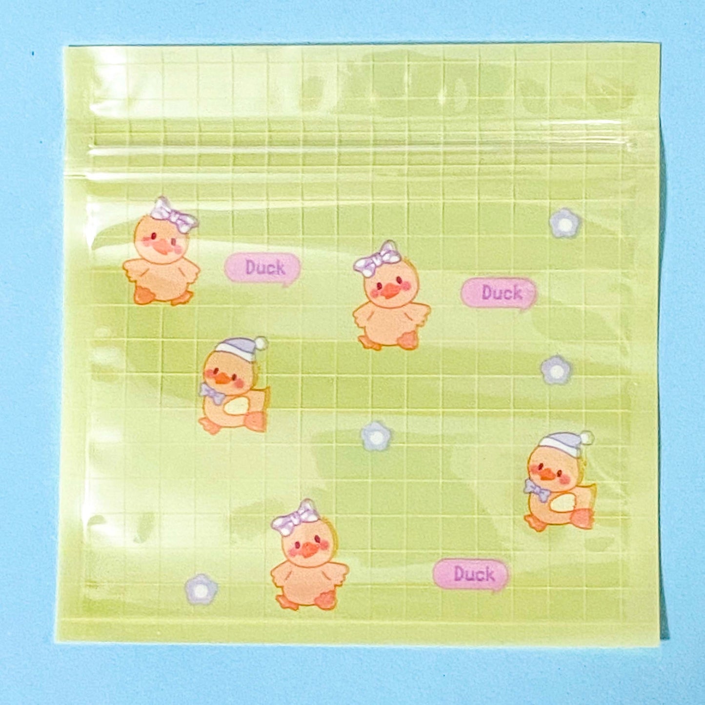 plastic re-sealable bag in yellow with cartoon duck illustrations on a blue background