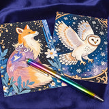 woodland and mythical animal art postcards set of 8 on a blue background