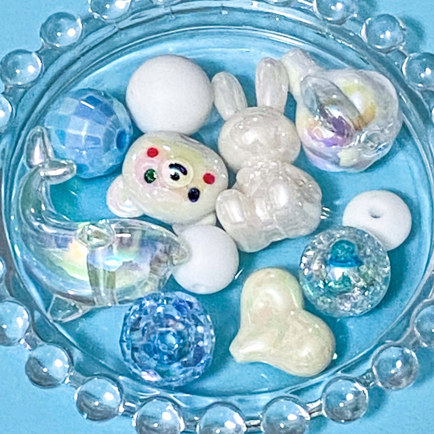 colour themed jumbo acrylic and silicone bead bundle in white and clear on blue background