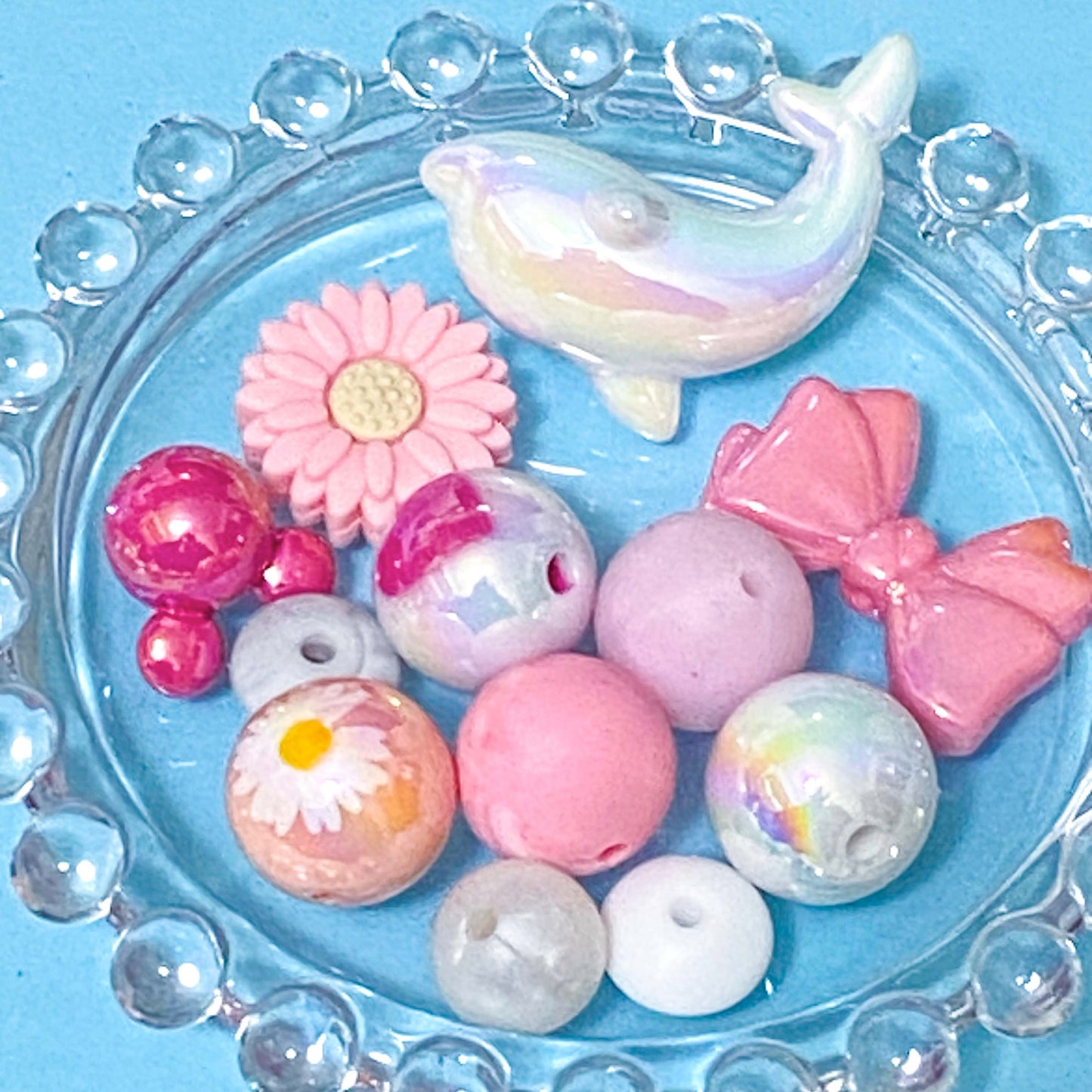 colour themed jumbo acrylic and silicone bead bundle in pink and white on a blue background