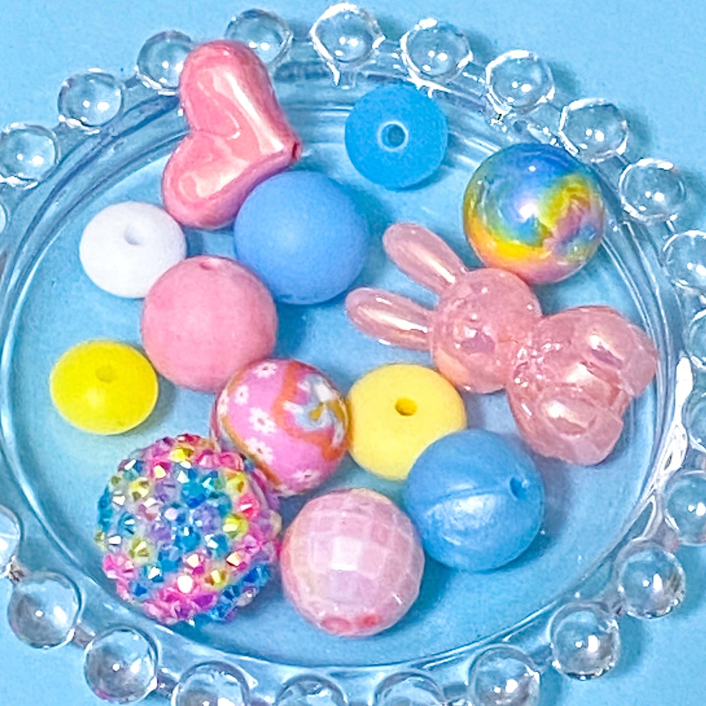 colour themed jumbo acrylic and silicone bead bundle in pastel spring colours on a blue background