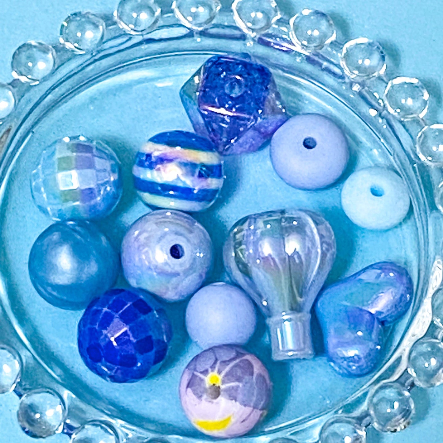 colour themed jumbo acrylic and silicone bead bundle in blue on a blue background