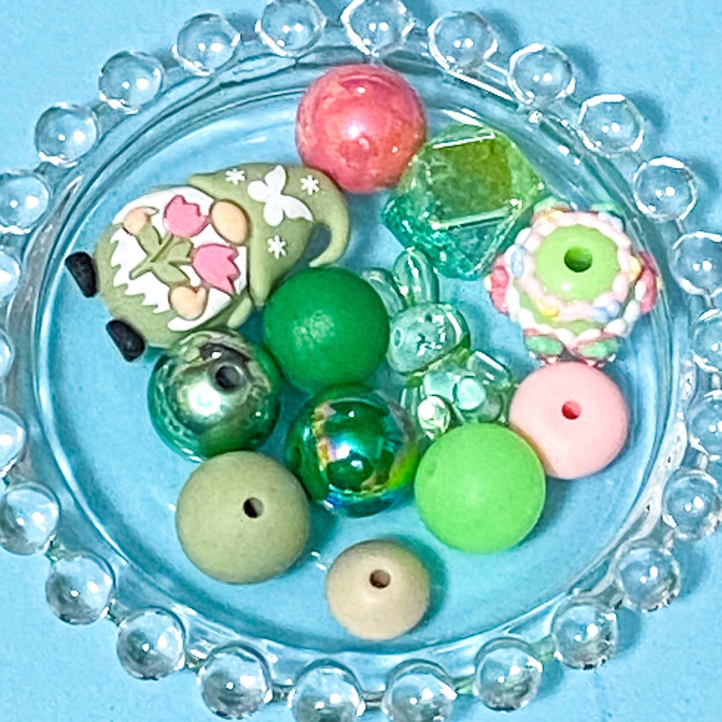 colour themed jumbo acrylic and silicone bead bundle in mint green and pink on a blue background