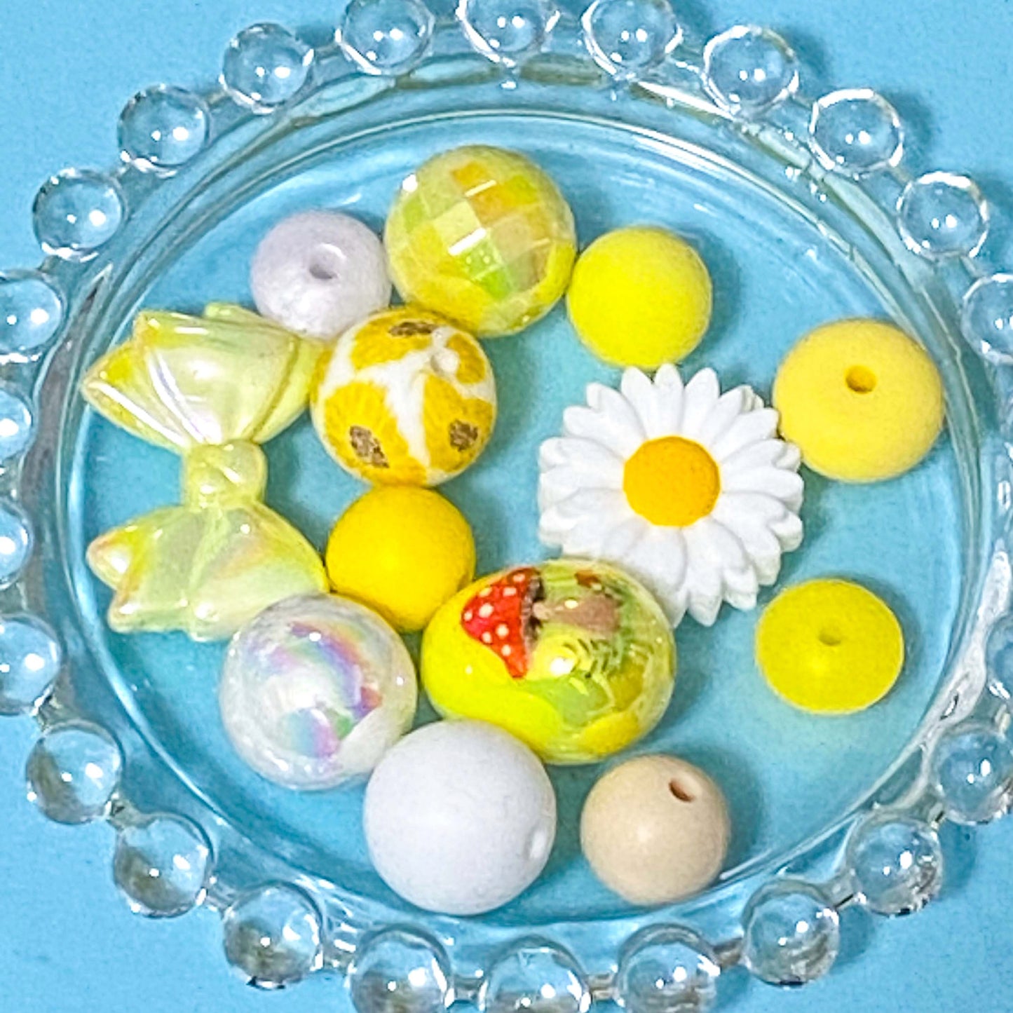 colour themed jumbo acrylic and silicone bead bundle in yellow and white on a blue background