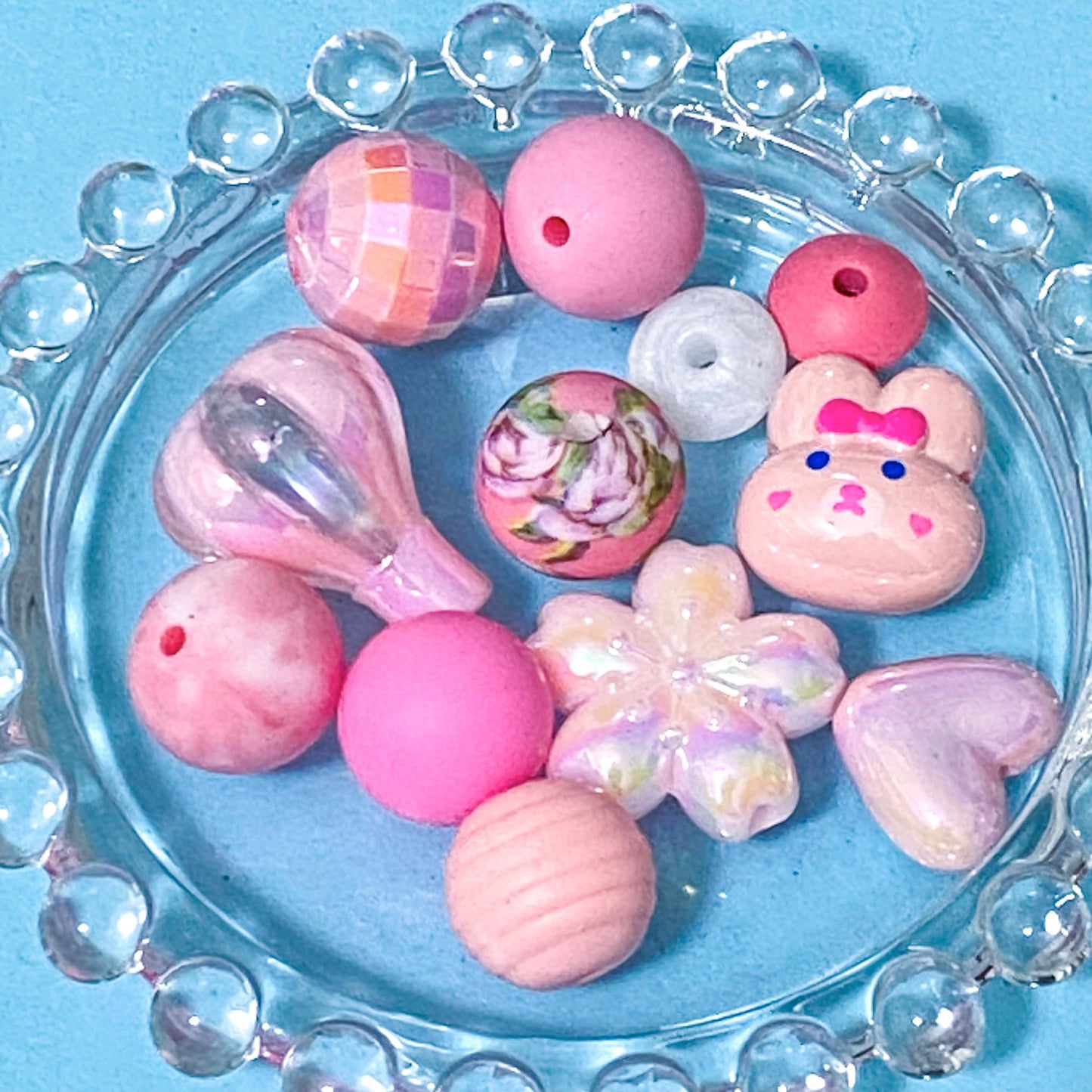 colour themed jumbo acrylic and silicone bead bundle in pink on a blue background