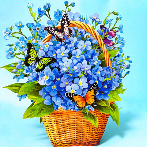 3d pop up card of a basket of blue forget me nots and butterflies on a blue background