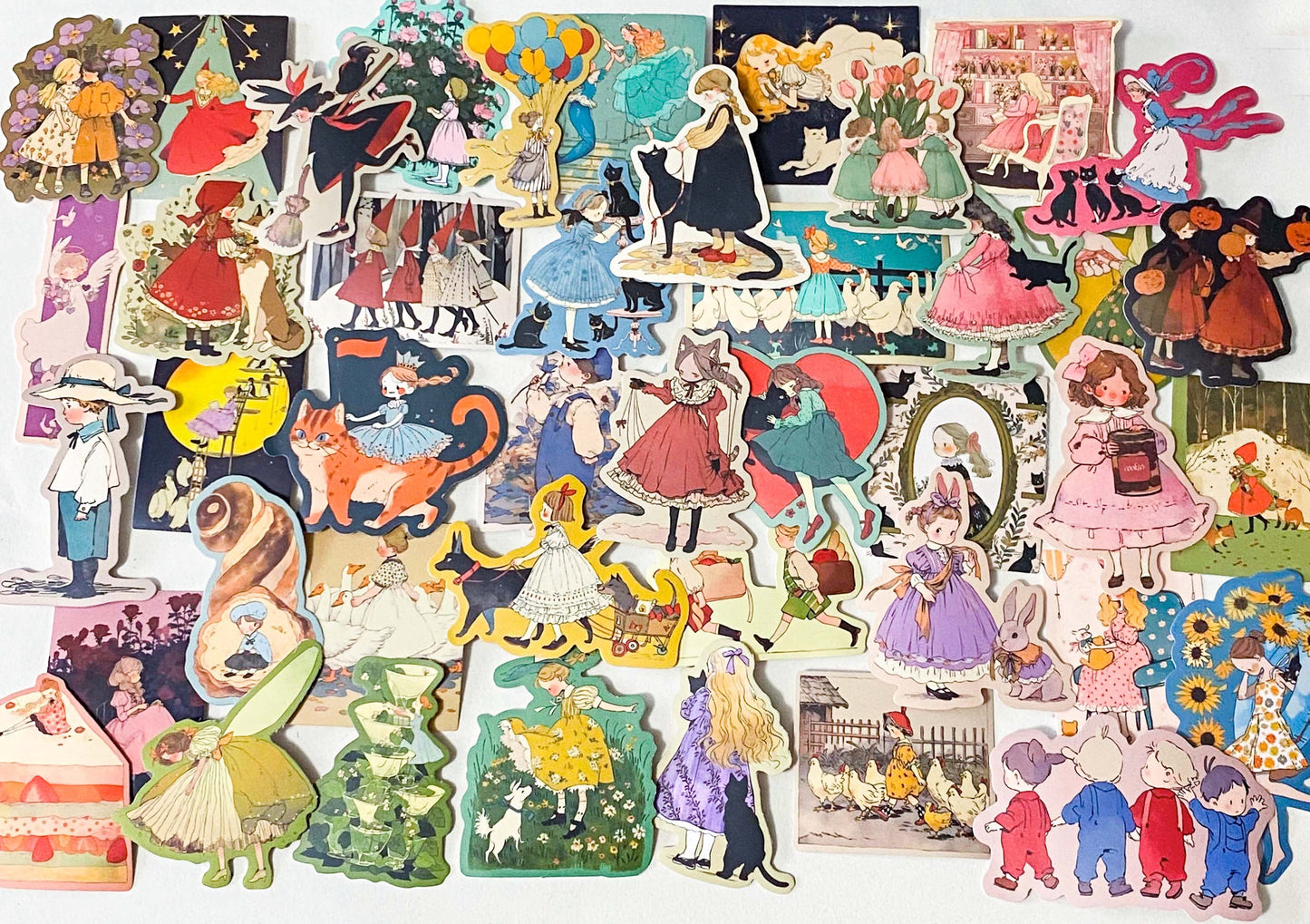 set of 50 vintage storybook style matte stickers featuring children, whimsical animals, cats and illustrated scenes in soft pastel and jewel tones for laptops and journaling