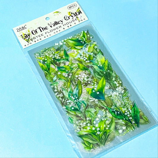 pack of 6 sheets clear plastic lily of the valley green and white stickers on a blue background