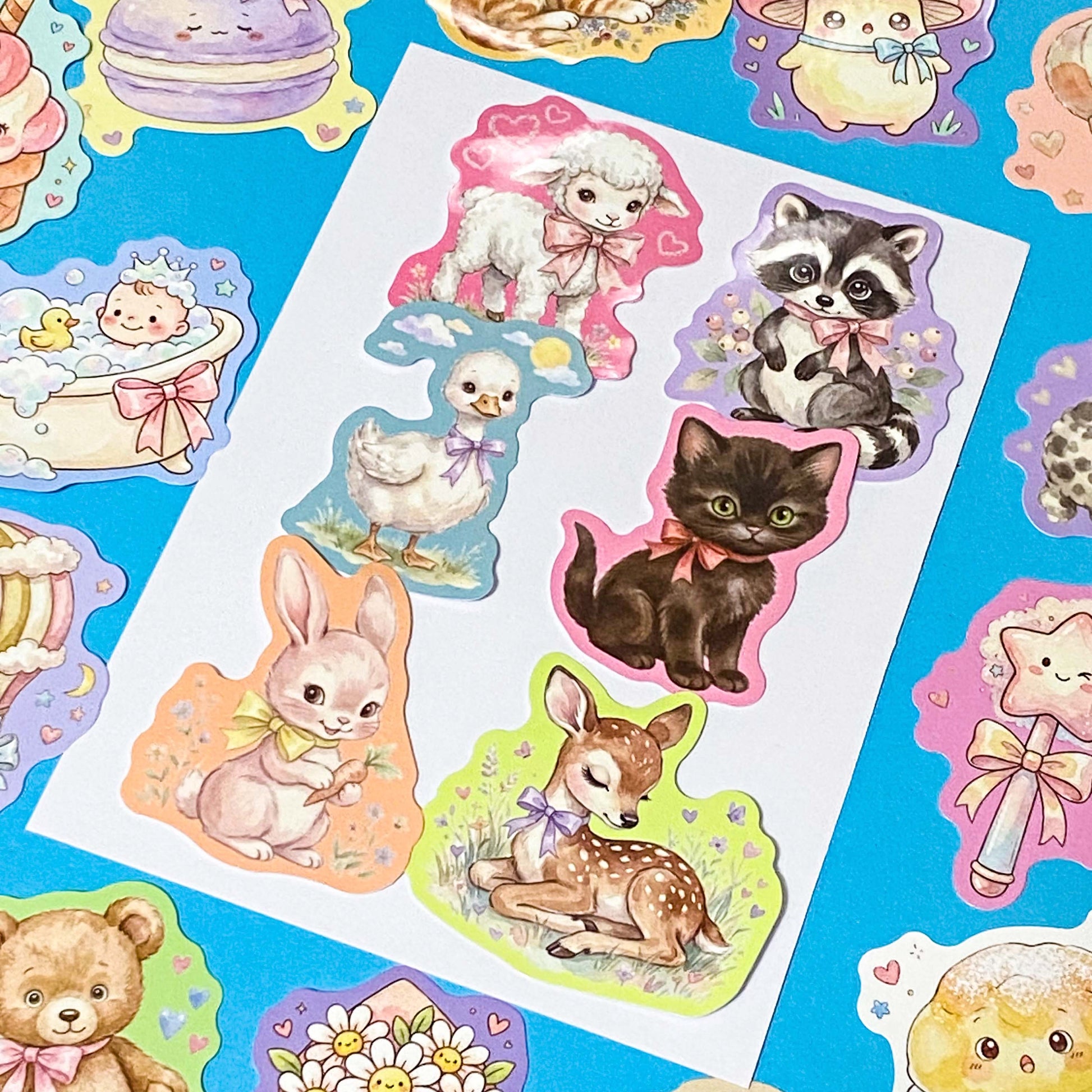 pack of 50 glossy pastel storybook stickers featuring baby animals, woodland creatures, sweet desserts and cakes, cosy drinks and whimsical kawaii illustrations, approx 53mm each. 