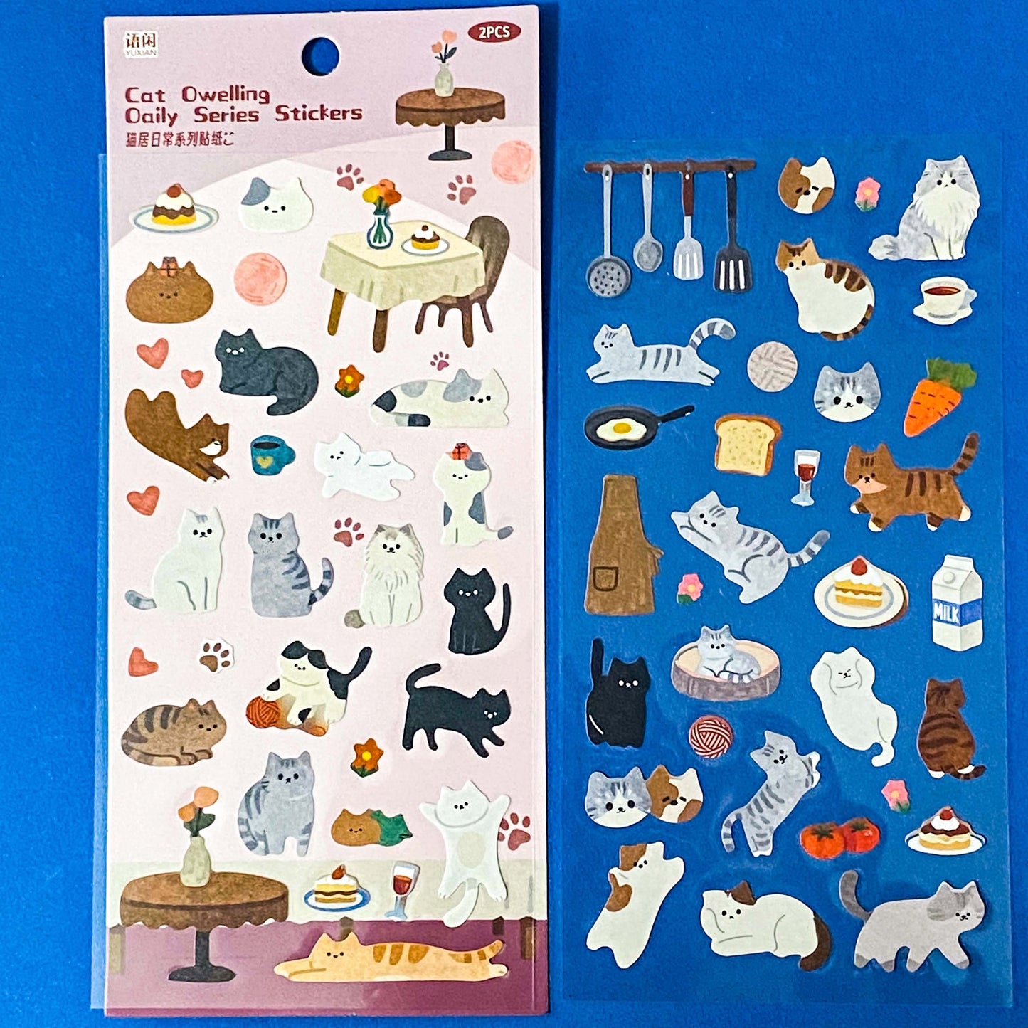 the secret life of cats matte clear sticker PET pack of 2 sheets featuring cosy illustrated cats and home scenes. Choose from the blue sitting room, the moonlit music room or the little cat cafe. UK stationery shop.
