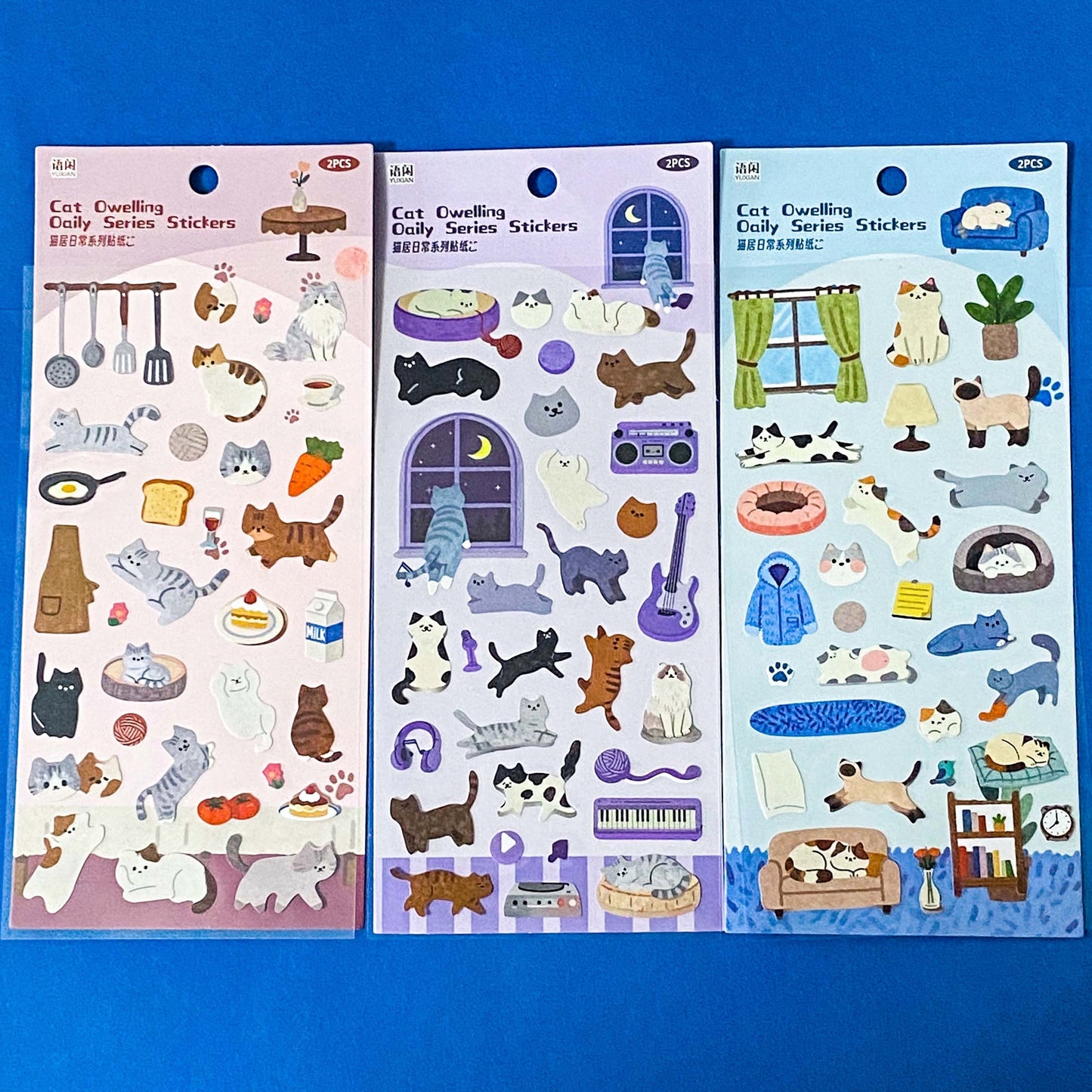 the secret life of cats matte clear sticker PET pack of 2 sheets featuring cosy illustrated cats and home scenes. Choose from the blue sitting room, the moonlit music room or the little cat cafe. UK stationery shop.