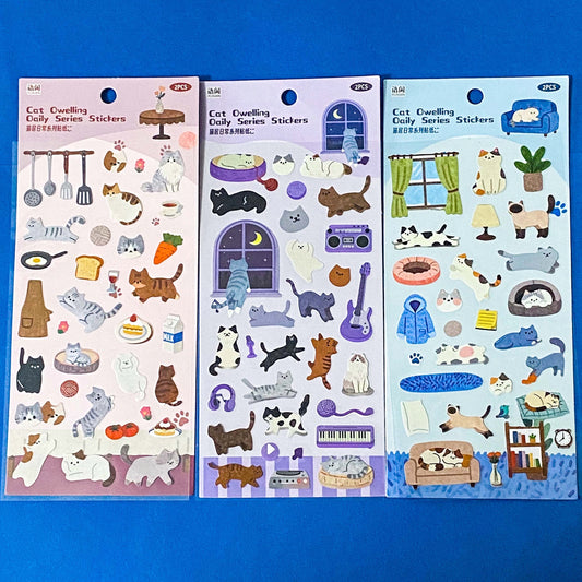 the secret life of cats matte clear sticker PET pack of 2 sheets featuring cosy illustrated cats and home scenes. Choose from the blue sitting room, the moonlit music room or the little cat cafe. UK stationery shop.