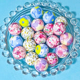 floral print and butterfly pattern large round 16mm silicone beads on a blue background