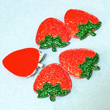 iridescent shimmery red strawberry patches on a blue background