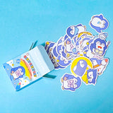 set of penguin kawaii sticker flakes in a mini box on a blue bacckground