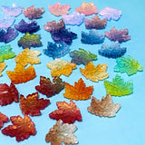 17mm glass maple leaf beads on a blue background