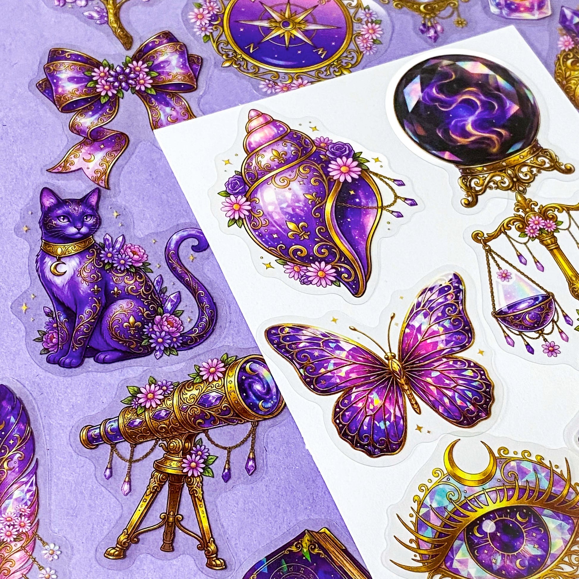 50 different violet oracle witchcore peT stickers featuring crystal balls, tarot cards, butterflies, celestial eyes, candle, skull, moons, potions, flowers, cat, magical purple illustrations. uk stationery gift shop.