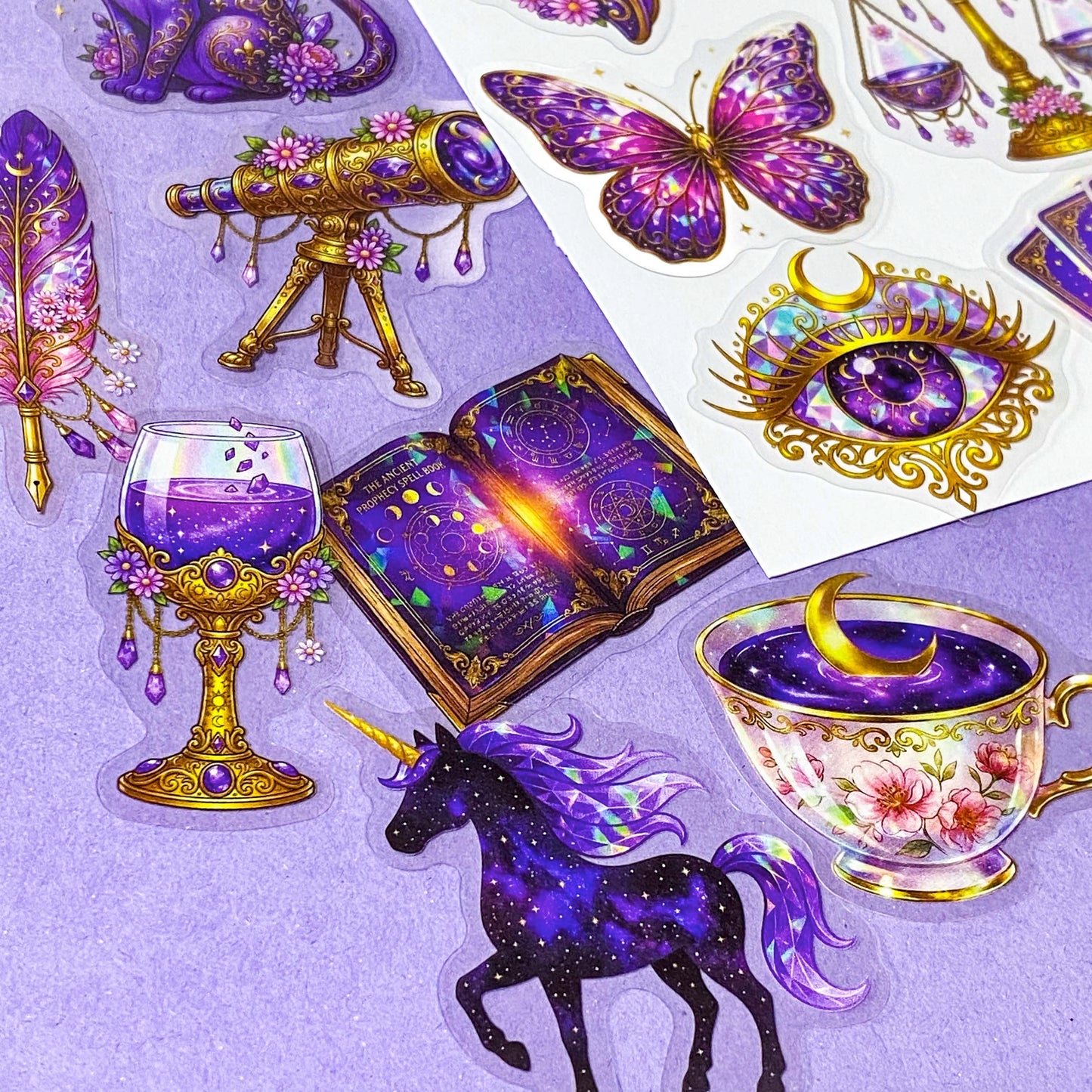 50 different violet oracle witchcore peT stickers featuring crystal balls, horses, tarot cards, butterflies, celestial eyes, candle, skull, moons, potions, flowers, magical purple illustrations. uk stationery gift shop.