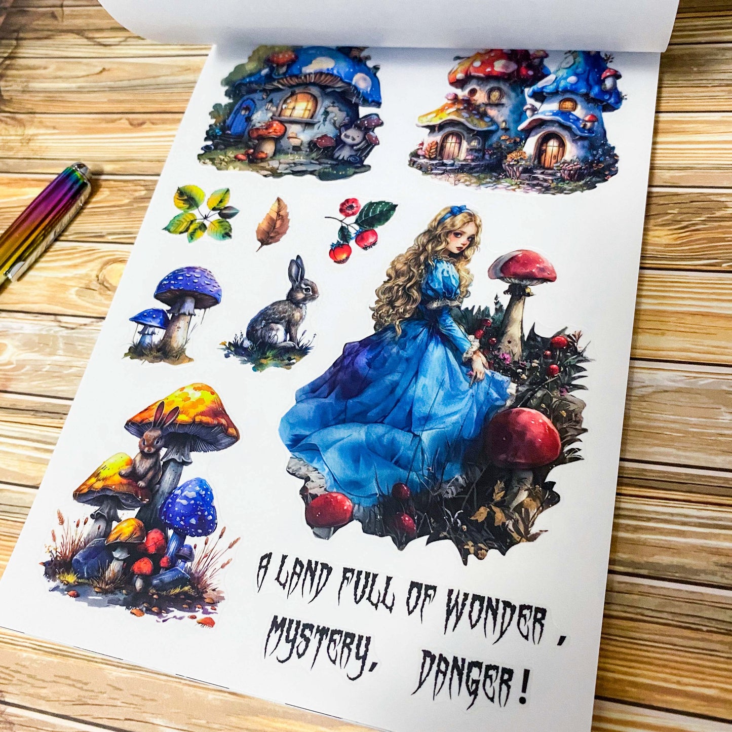 large Alice's Journey paper sticker book featuring 20 big matte pages of wonderland inspired fantasy stickers with castles, mushrooms, florals, vintage frames and blue fairytale illustrations