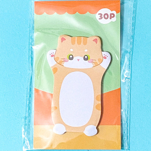 ginger Cat-shaped sticky note pad on a blue background