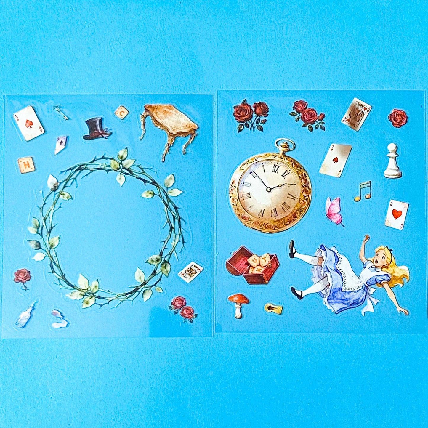 large alice inspired falling into wonderland sticker set with oversized now globe scene card, transparent PET stickers, pocket watch, roses and playing cards details on pink backing card with bow