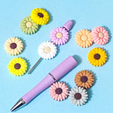 silicone daisy flower large beads with a pen blank on a blue background