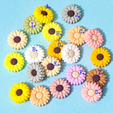 colourful silicone daisy beads on a blue background